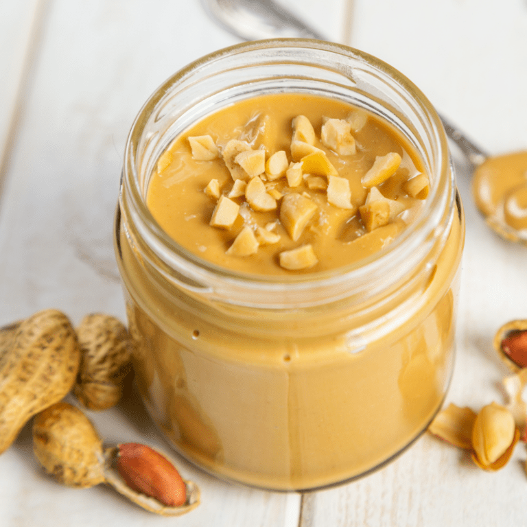 cat with peanut butter container and spoon
